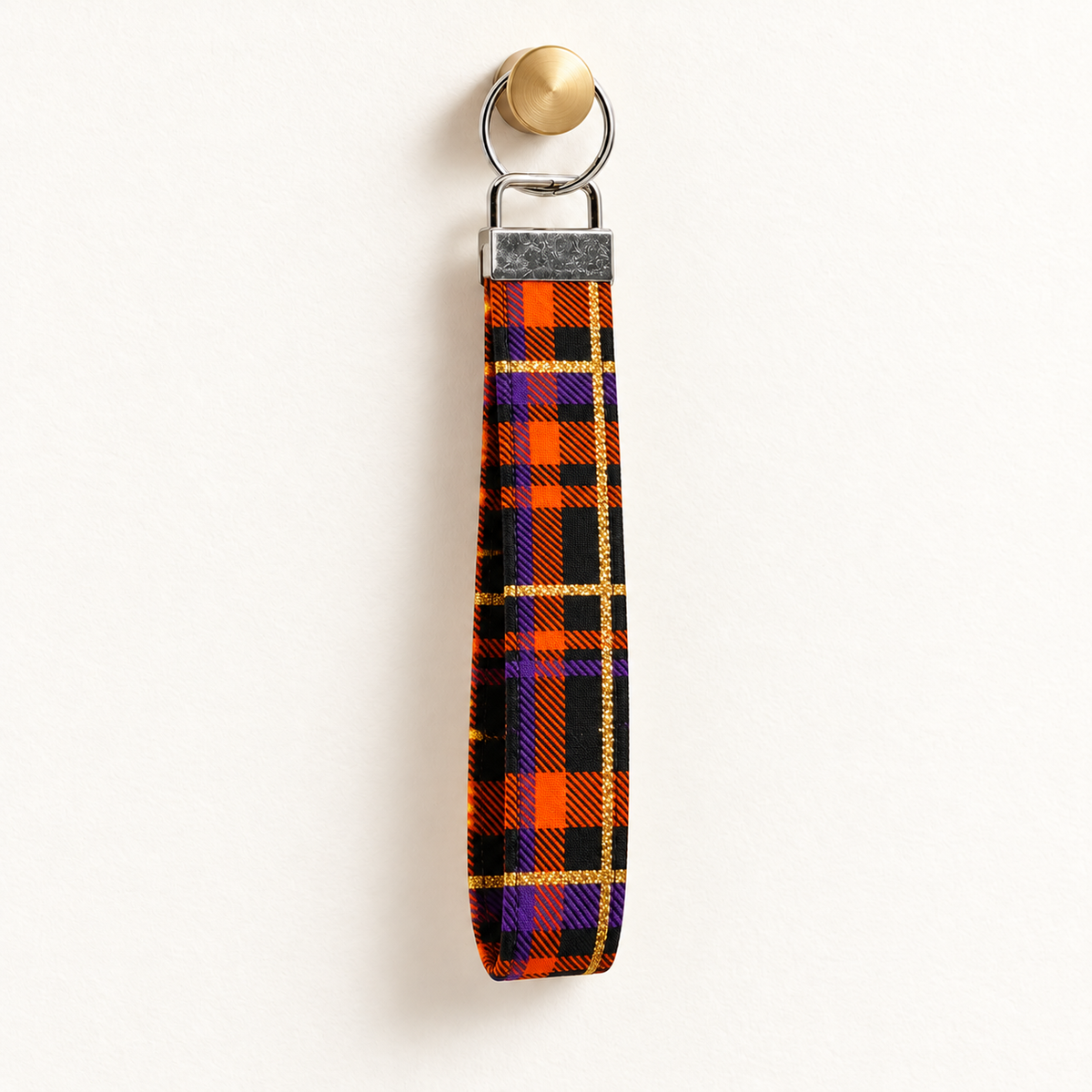 Plaid Behavior – Fabric Wristlet Keychain hanging from a gold wall knob