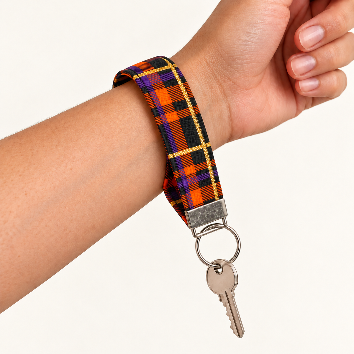 Plaid Behavior – Fabric Wristlet Keychain worn around a wrist with a key attached