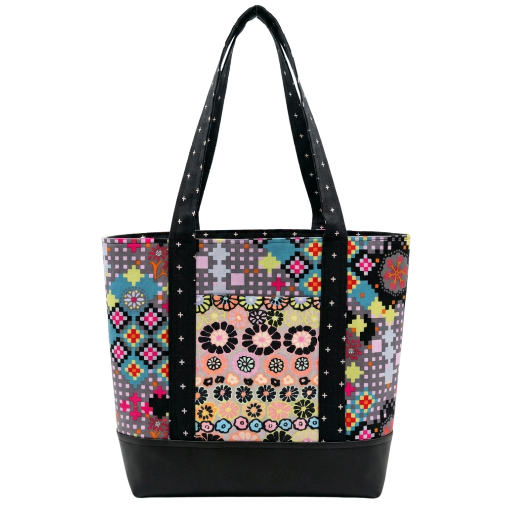 Handmade cotton tote bag with retro pixel floral pattern and black cross detail straps