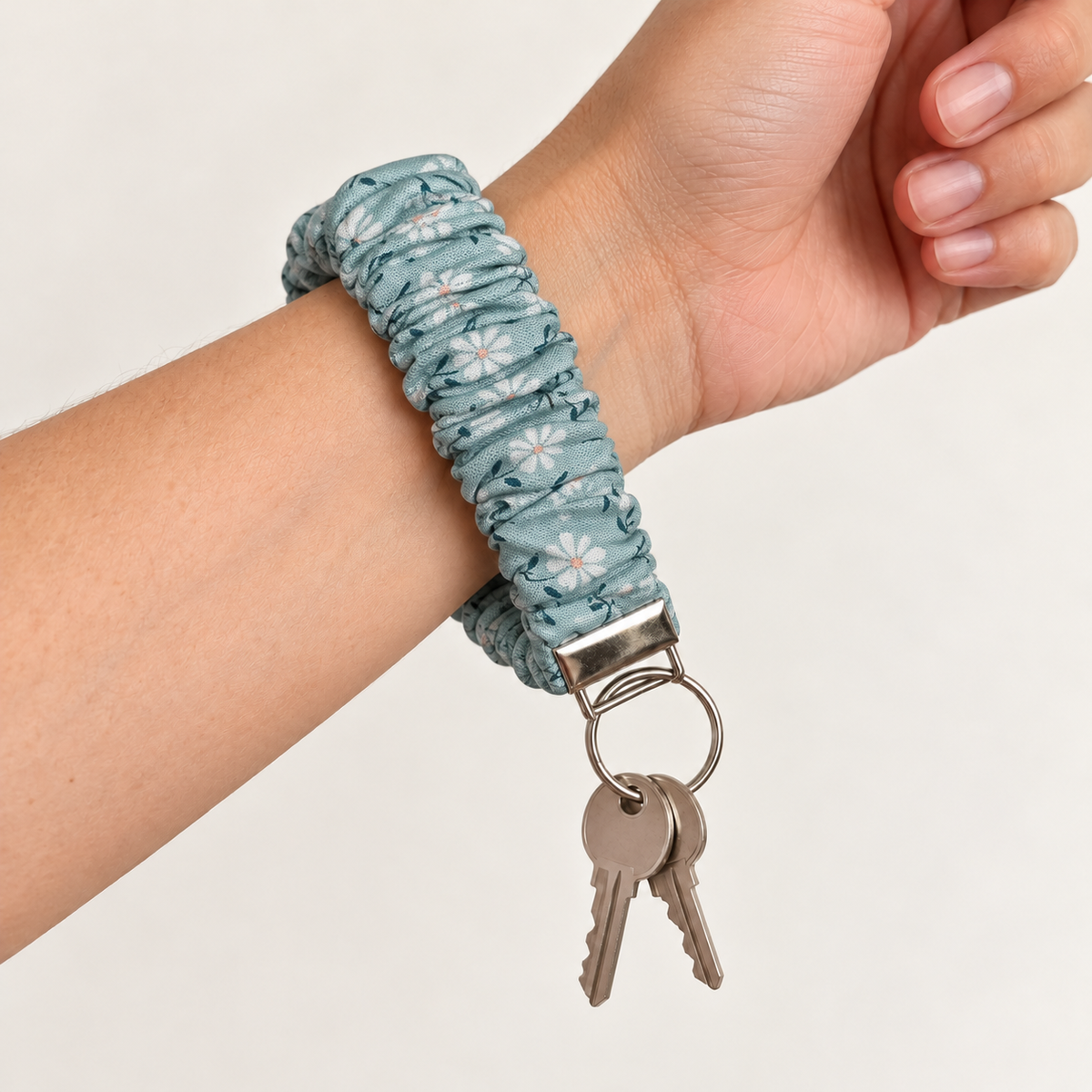 daisies scrunchie wristlet worn on wrist with keys