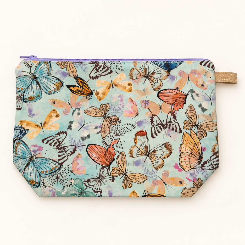 Social Butterfly pastel butterfly cotton pouch laid flat with lavender zipper.