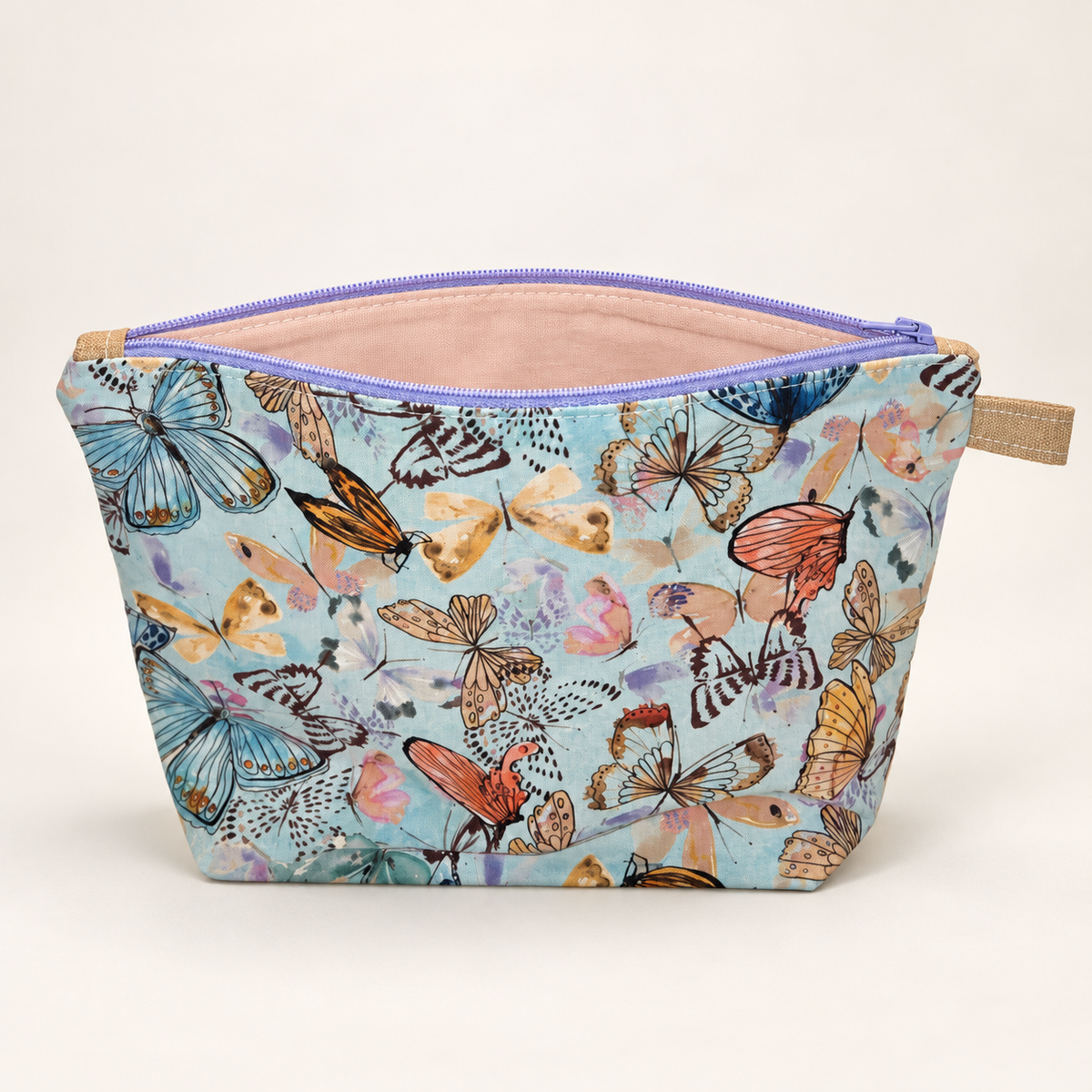 Social Butterfly pastel butterfly cotton pouch standing with blush lining visible.