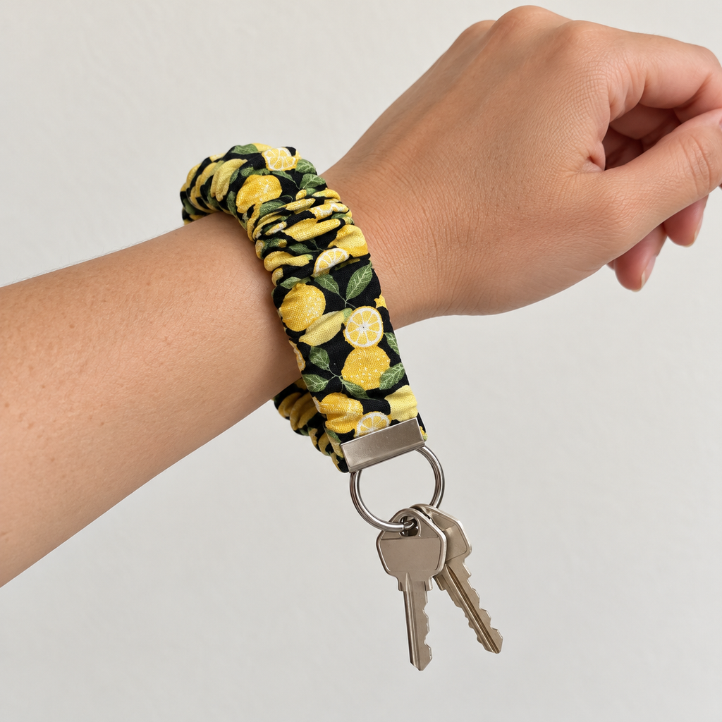 Squeeze the Day lemons scrunchie wristlet worn on wrist with keys