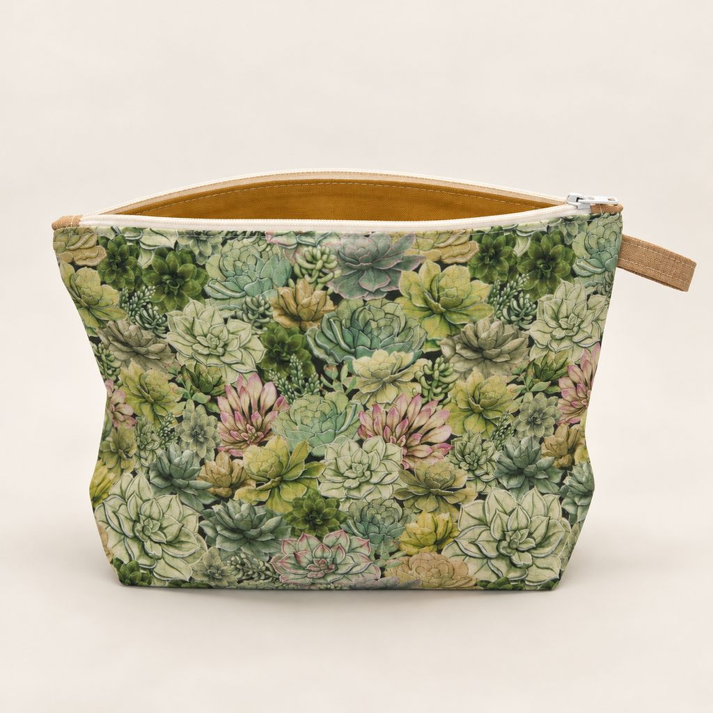 Succ It Up succulent print cotton zipper pouch standing upright with mustard lining visible.