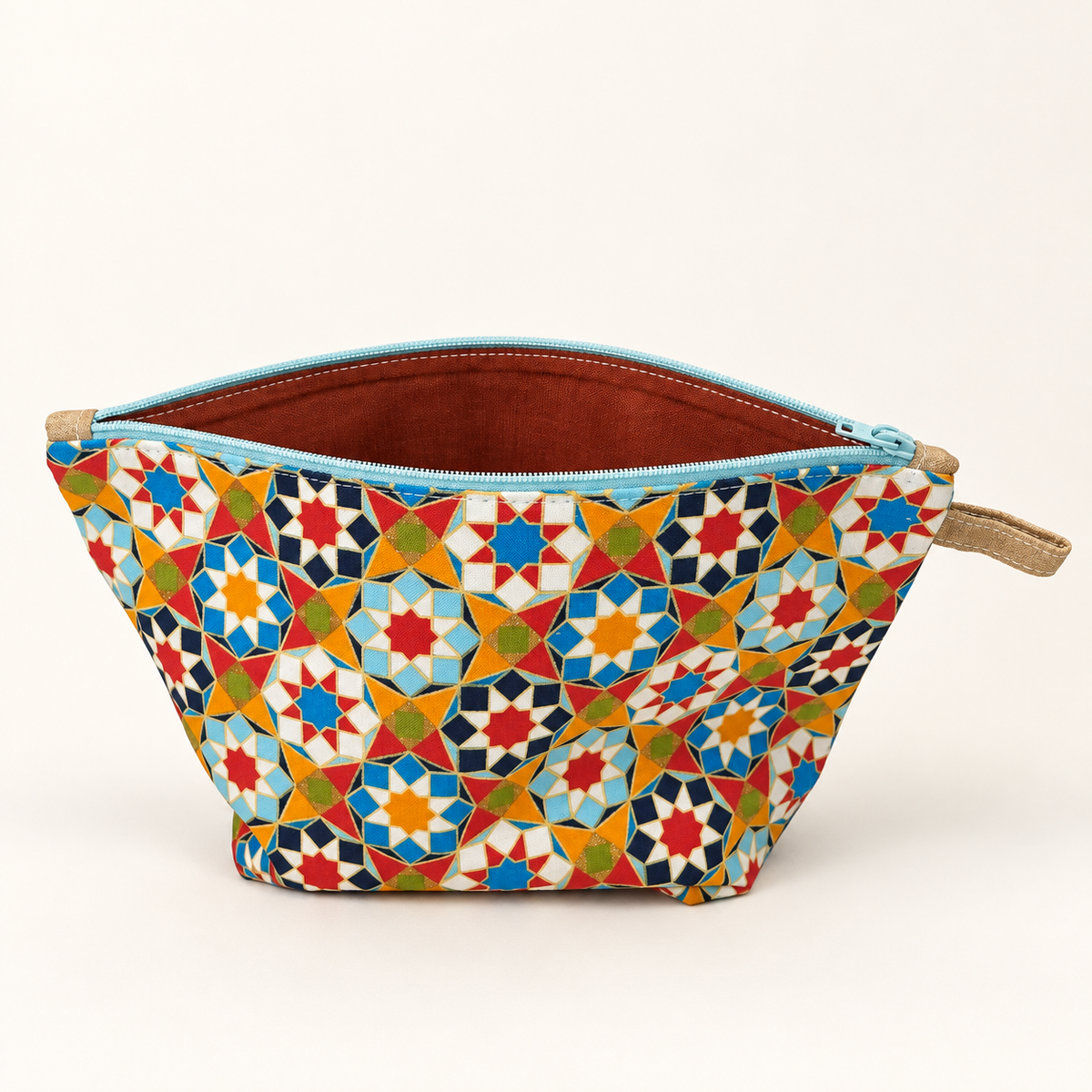 Tile Me More geometric cotton pouch with pale aqua zipper, standing view showing rust lining
