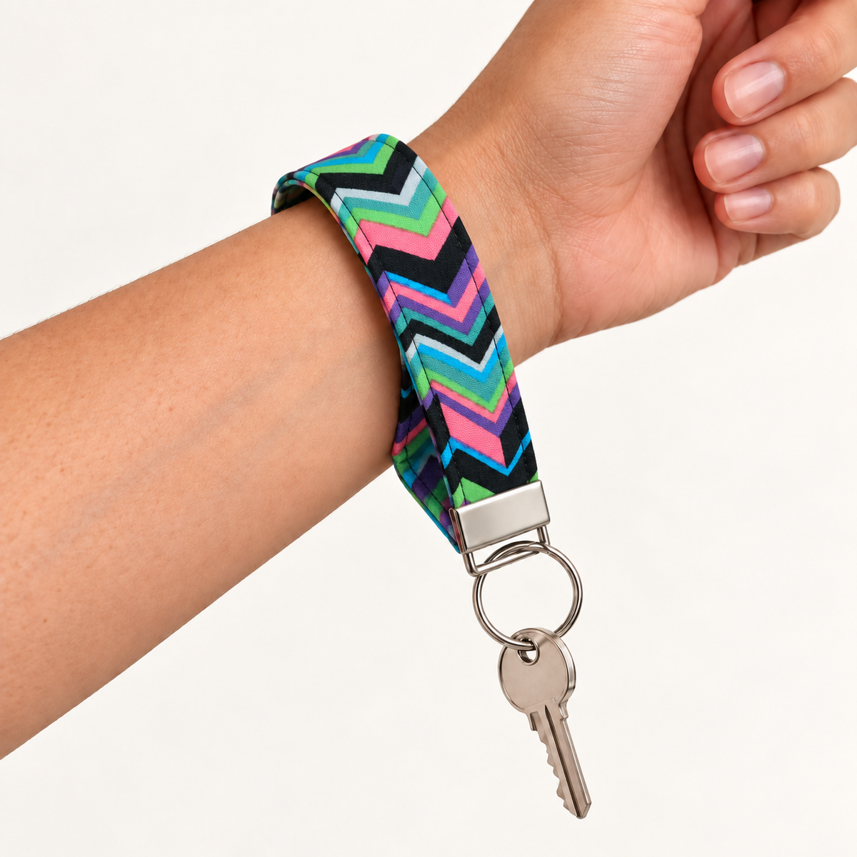 Zig Happens – Fabric Wristlet Keychain worn around a wrist with a key attached